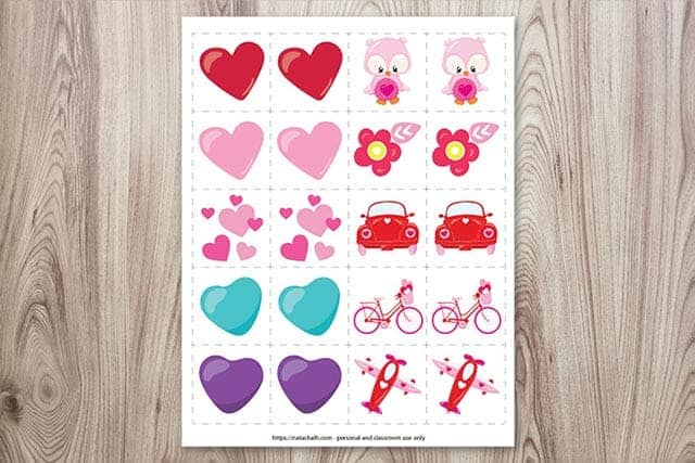 A preview of a free printable set of matching game cards for Valentine's Day on a wood background
