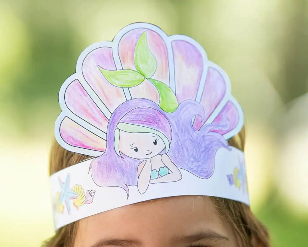 A picture of a young child wearing a headband with a mermaid on it. The child is shown close up so that only her eyebrows are visible.