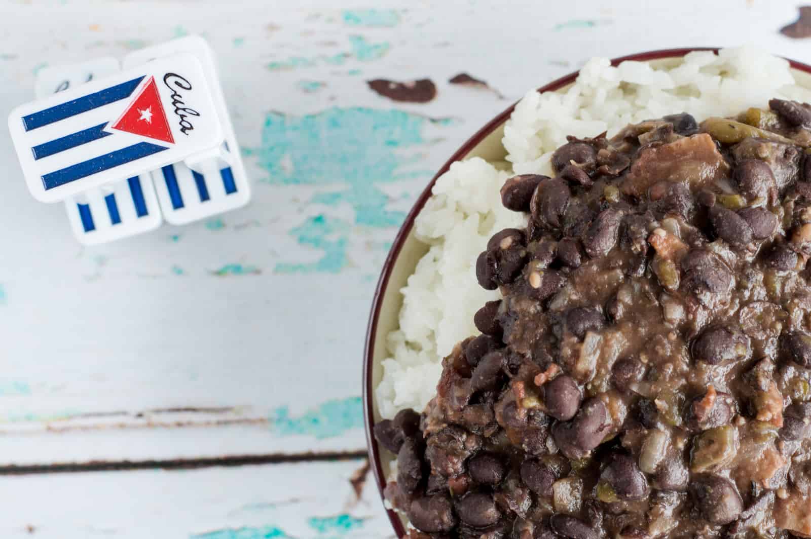 black beans and rice next to Cuban flag dominos