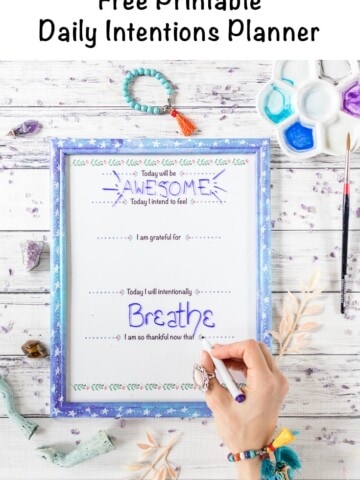 Free printable daily intentions planner in a galaxy frame with overlay text