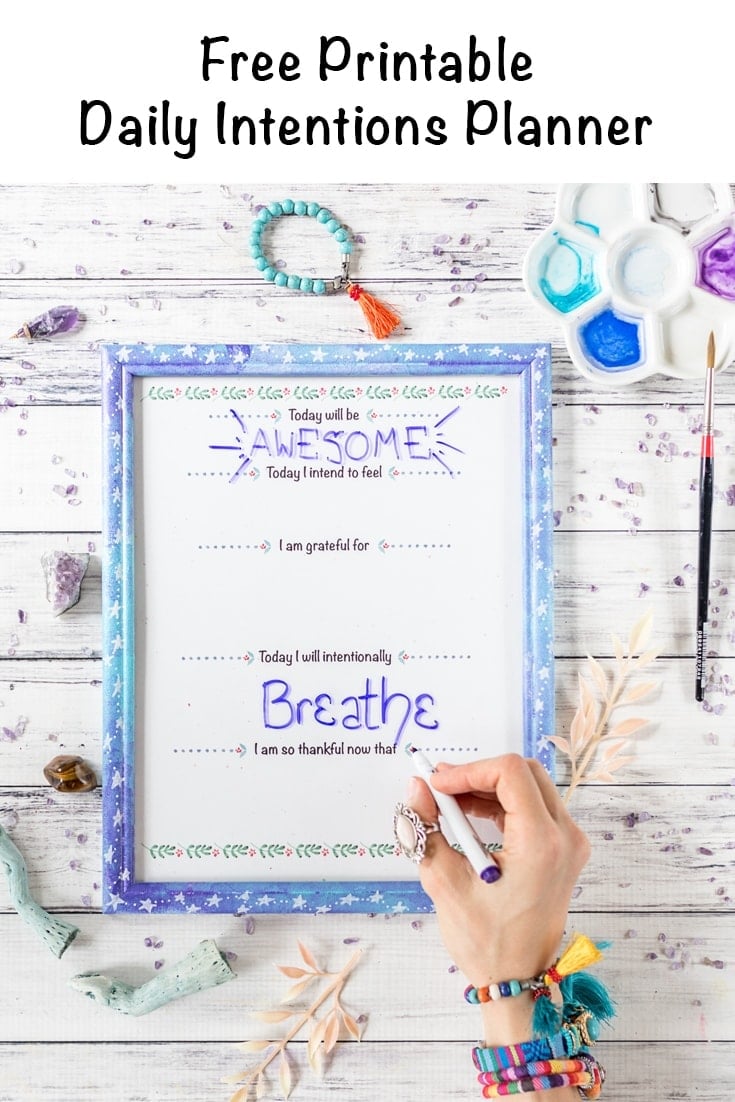 Free printable daily intentions planner in a galaxy frame with overlay text