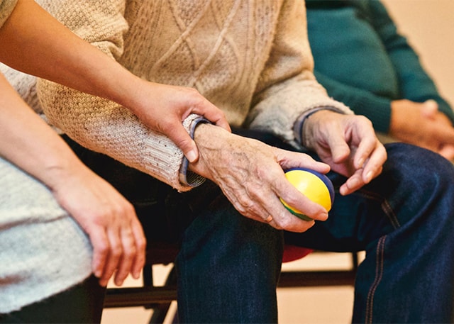 a younger adult helping elderly