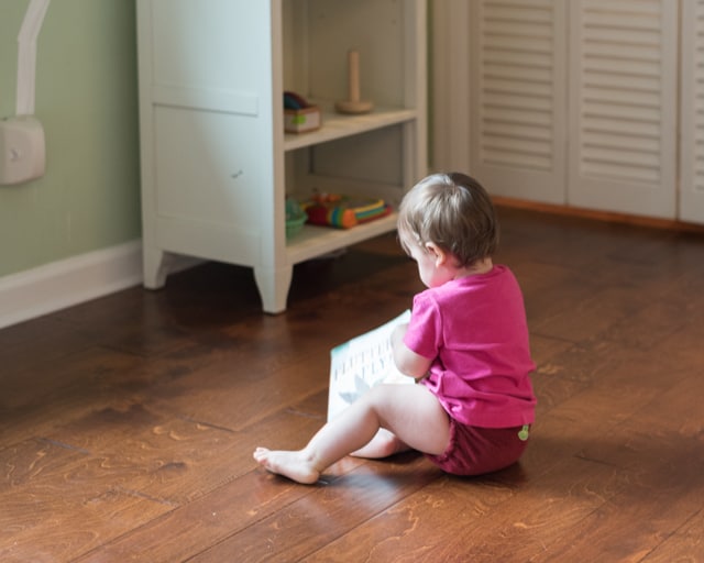 baby playing with an indestructibles book