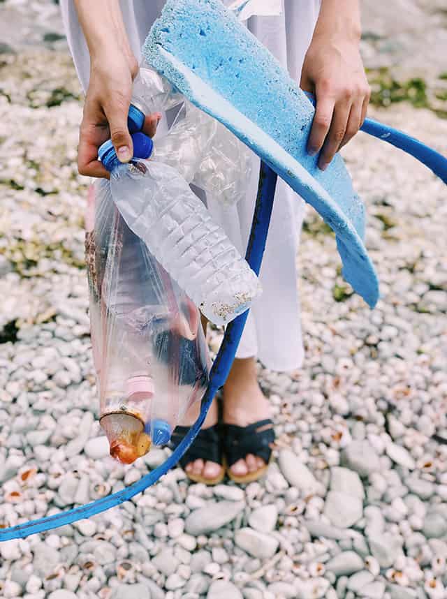 picking up litter on the beach