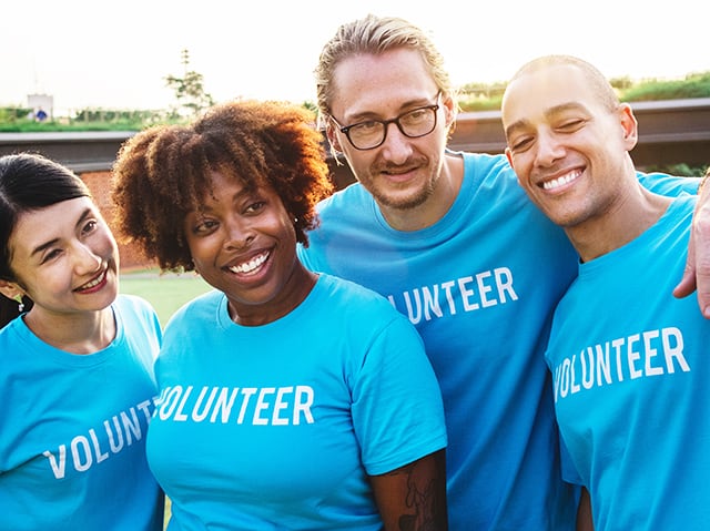 volunteers in blue shirts