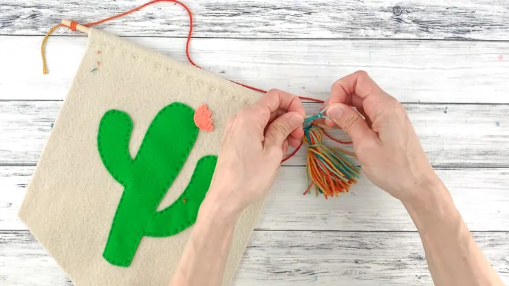 adding a tassel to cactus wall hanging