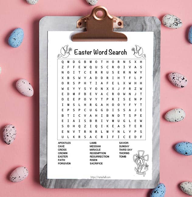 Black and white religious Easter word search printable on a marble clipboard. The clipboard is on a pink background with speckled Easter eggs