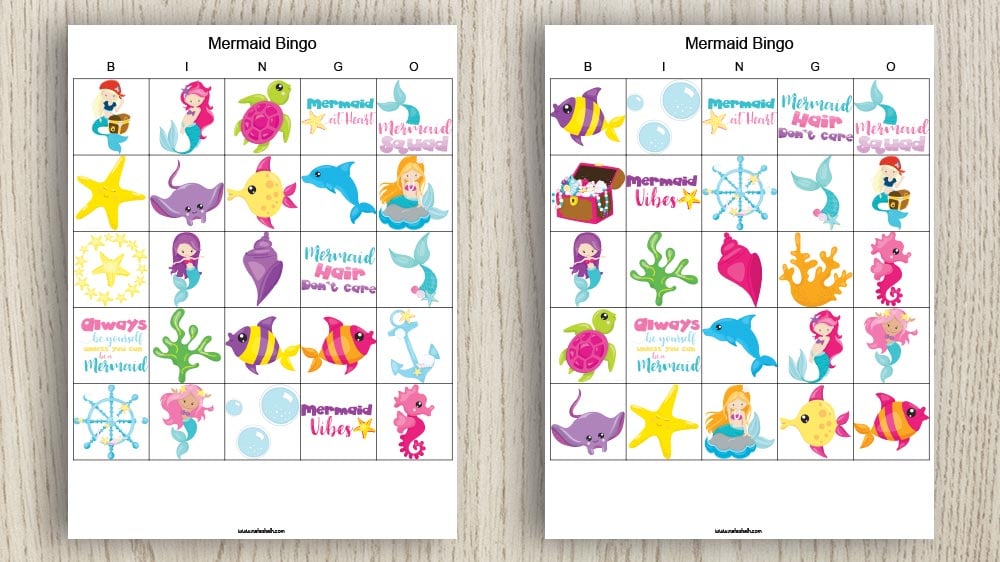 two free printable mermaid bingo boards on a wood background