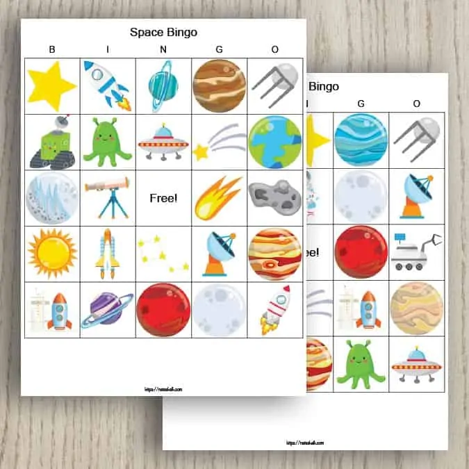 Two free printable outer space bingo cards. The cards feature a 5x5 grid of cartoon space images including planets, satellites, telescopes, and stars.