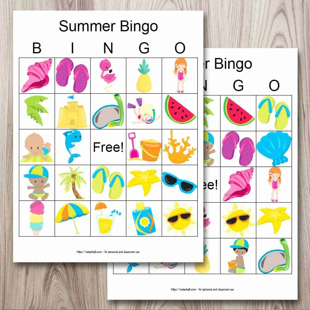 Two printable summer bingo cards on a wood background. The cards are placed so that one is on top of the other, obscuring half of the card behind. Each bingo card printable features 24 cartoon summer images like a beach ball, flip flops, an umbrella, and ice cream.