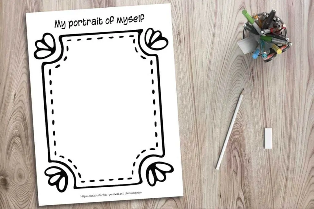A printable worksheet mockup on a wood background with a cup of colorful pens, a pencil, and an eraser. The worksheet says "a portrait of myself" across the top and has a large hand drawn frame around the edge of the page