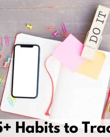 text overlay "75+ habits to track" on a picture of an open blank journal with a large clip reading DO IT, a blank phone, and an assortment of rubber bands, push pins and paper clips