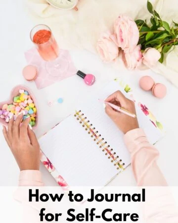 text overlay "how to journal for self-care" at the bottom of an image of a woman in a pink shirt journaling next to macrons, a bowl of candy hearts, a glass of pink champaign, a bottle of nail polish, and a bouquet of pink flowers.