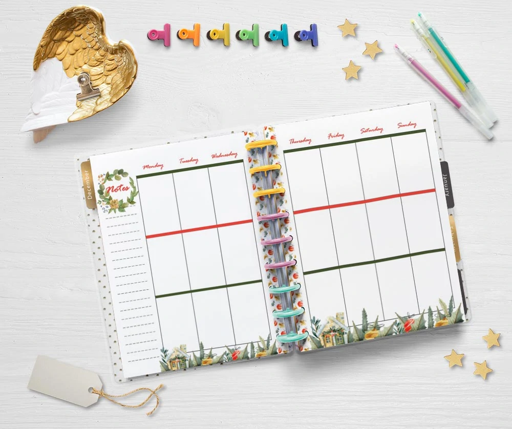 A flatly of an open Happy Planner Classic with printable interests for December. There are planning supplies like gel pens and binder clips as well as a Christmas gift tag and small stars on the table around the planner