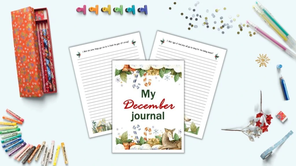 A flatly mockup with journaling supplies and three journal pages in the center on a light blue background. The pages include "My December Journal" with watercolor illustrations in the front and center. Behind are two lines pages with journal prompts at the top and a watercolor border at the bottom. Props on the surface include gel pens, glitter, blue washiest tape, and a Japanese pencil case with red flowers and pencils.