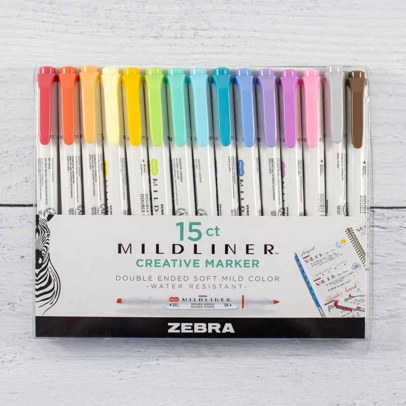 A box of 15 Zebra brand milliner markers/highlighters on a white wood background