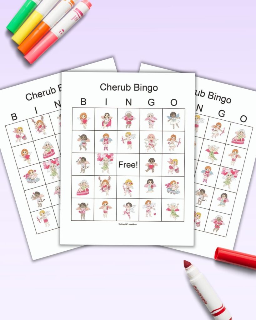 A flatlay mockup of three printable picture bingo cards with Valentine's cherubs on a light purple background. There are colorful children's markers on the background with a red open marker on the bottom right corner, as if ready to mark the bingo cards.