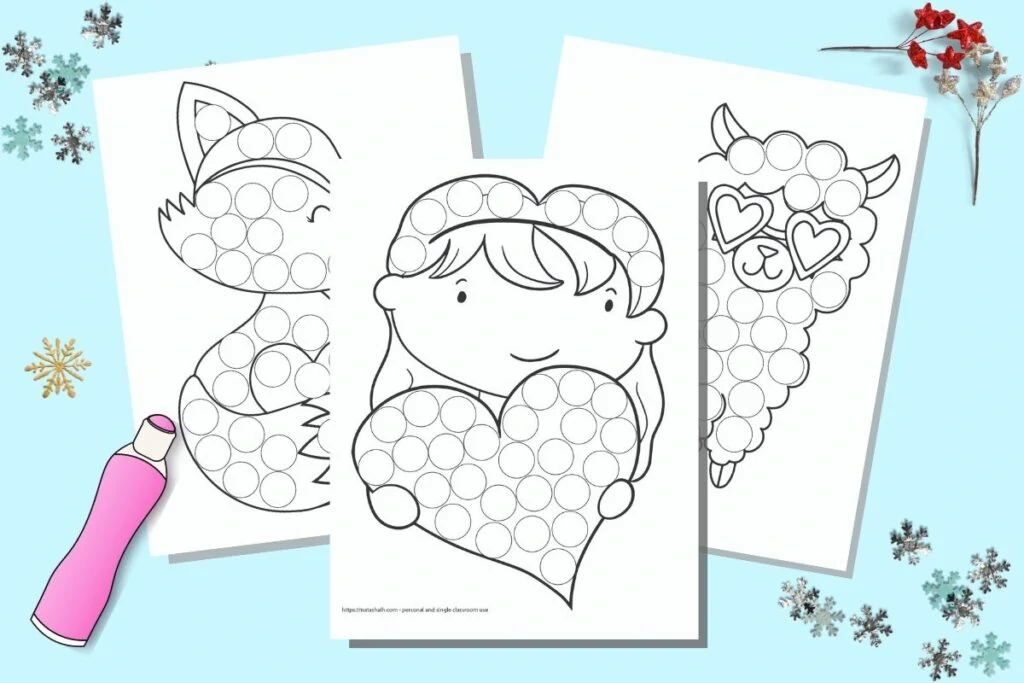 Three printable dot marker pages on a blue background with a pink cartoon dauber markers and snowflake confetti. The coloring pages feature a girl with a heart, a fox, and a llama with heart shaped glasses. 