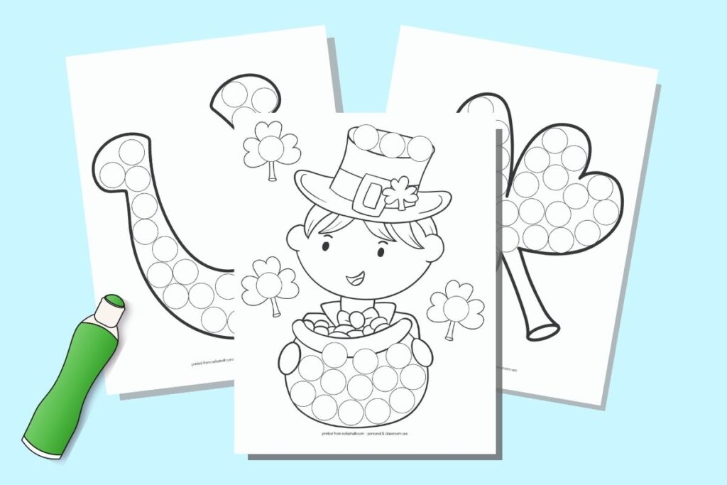 A preview of three printable St. Patrick's Day do a dot coloring pages on a blue background with a drawing of a green bingo dauber marker. The front and center page has a boy with a top hat and pot of gold. Behind are a large shamrock and a lucky horseshoe. Each image is filled with circles to dot in.