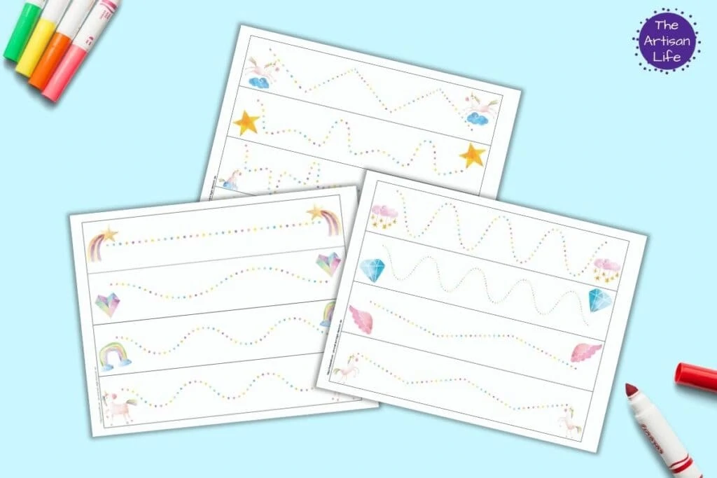 Three free printable unicorn themed prewriting practice printable pages. Each page has four rainbow dotted lines to trace. The lines run between two unicorn themed images. The pages are on a blue background with colorful children's markers. 