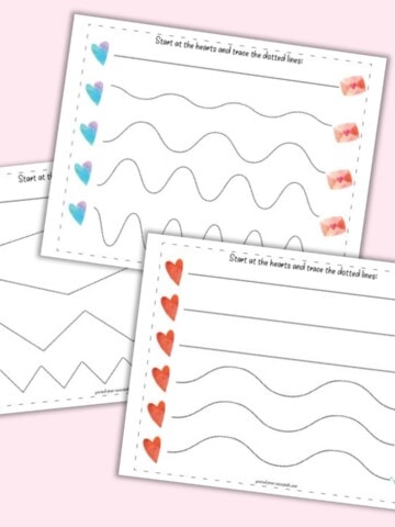 A flatlay mockup with three printable Valentine's Day tracing worksheets. Each page has a row of five hearts on the left followed by five dotted hearts to trace. Pages include straight, wavy, and zig-zag lines