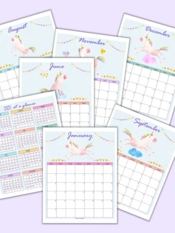 a flatlay mockup of 7 printable unicorn calendar pages for 2021 including a year at a glance page and monthly pages