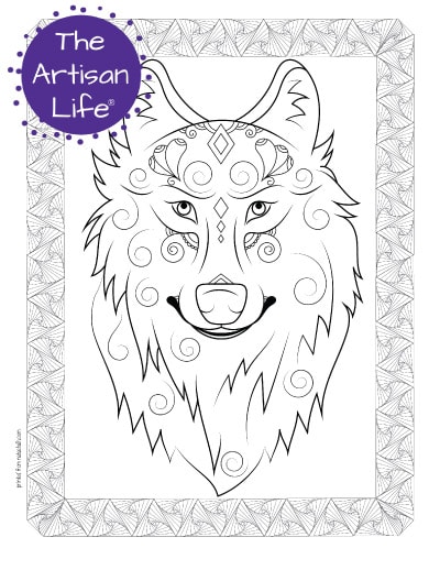 A preview of a wolf's face coloring page for adults. The wolf has hand drawn doodles and swirls to color and the page is bordered by a doodle frame. A purple round logo reading "the artisan life®" is in the corner.