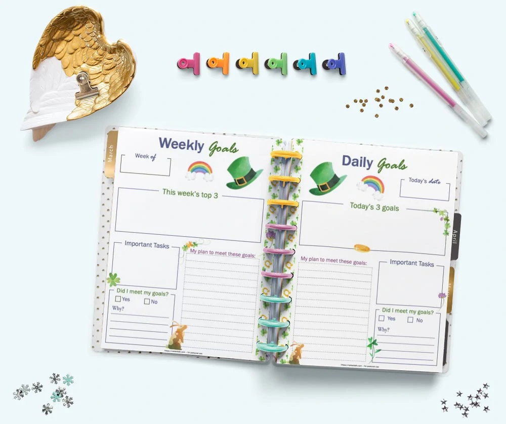 An open Happy Planner Classic on a blue surface showing weekly and daily goals planner pages with a st. Patrick's Day theme 