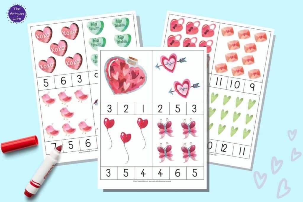 A preview of three printable Valentine's Day count and clip card pages. Each page has four cards with Valentine's Day images and three numbers 1-12 along the bottom edge. The pages are on a light blue background with a child's red marker.