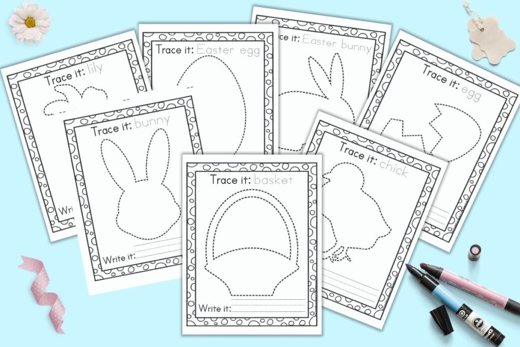Seven printable Easter tracing pages for preschoolers and kindergarteners. Each page has a dotted Easter image to trace and an Easter vocabulary word in a dotted font to trace. The pages are on a blue background with a pink and blue marker, a daisy, and a piece of pink ribbon.