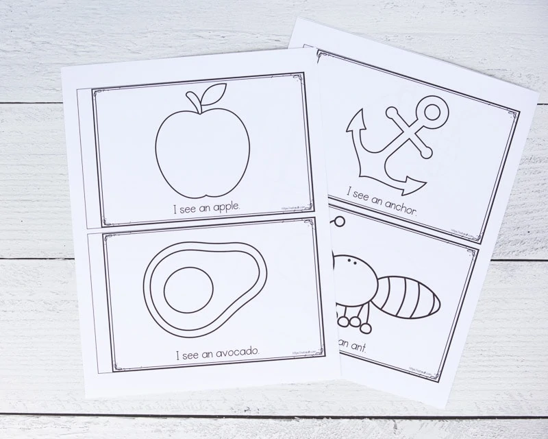 Two printed sheets for a printable letter a emergent reader book. The pages have black and white graphics to color and "I see an..." with an apple, avocado, anchor, and ant
