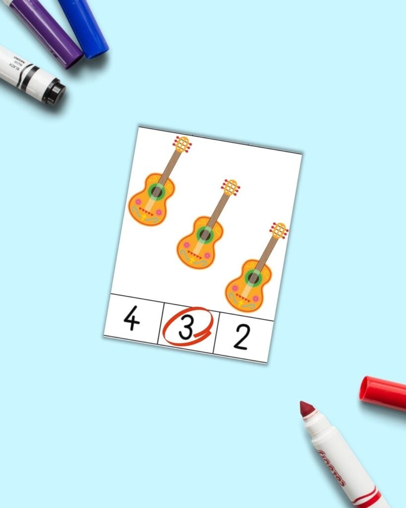 A count and clip card with three guitars. Across the bottom are numbers 4, 3, and 2. The 3 is circled in red.
