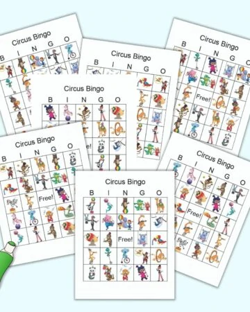 A preview of seven free printable circus bingo boards on a light blue background. An illustrated green dauber marker is the lower left corner. Each bingo card has 24 illustrated animal and circus images.