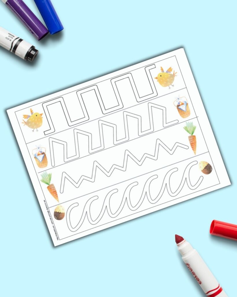A page with four difficult trace in the path lines for preschoolers. There is a piece of Easter clipart on each end - a chick, a basket, a carrot, and a chocolate egg. The sheet is on a blue background with colorful children's markers. 