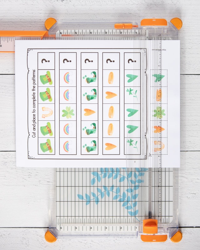 A St. Patrick's Day themed complete the pattern worksheet with five patterns for preschoolers to extend. The page is on a white and orange paper trimmer.