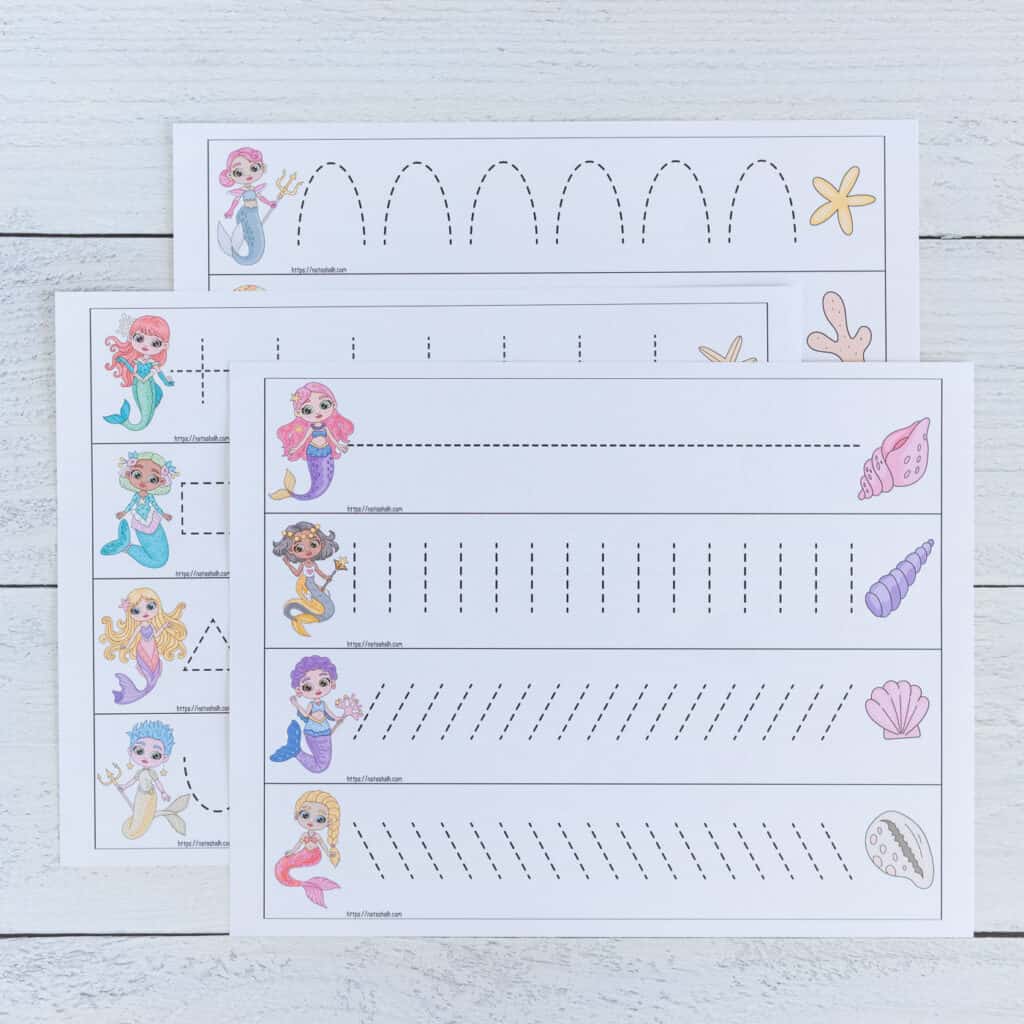 A preview of three pages of printable mermaid themed prewriting practice cards for preschoolers. Each page has four cards to cut out and trace. There is a mermaid on the left of each card and a shell on the right. Each card has a different dotted shape or line to trace. The pages are on a white wood background. 
