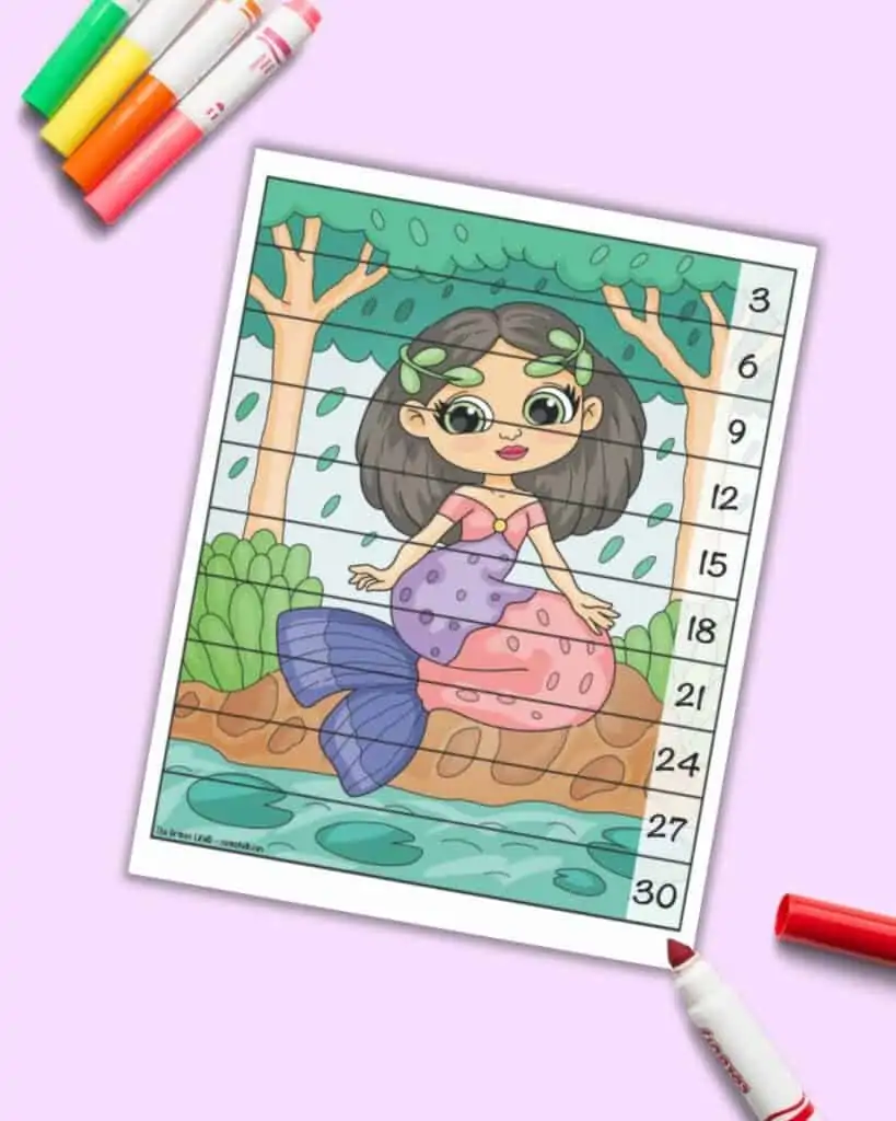 A skip counting by 3's number building puzzle with an image of a mermaid sitting on the shore