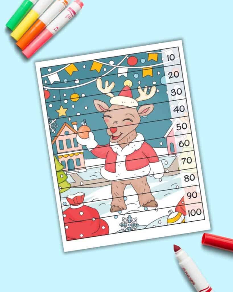 A number building puzzle with a reindeer holding an ornament. There are lines to cut the puzzle into 10 strips. Each rectangle has a number 10-100, counting by 10s, along the right hand side.
