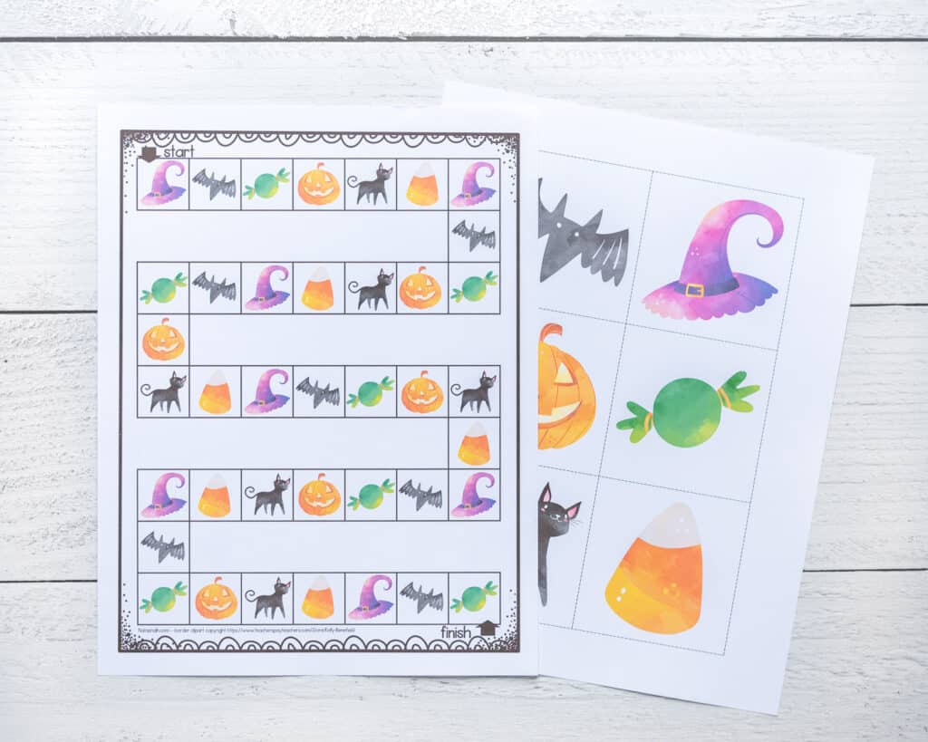 Two printed pages from a Halloween board game for preschoolers. Pages include the board game and a sheet with differentiated instruction cube inserts with Halloween clip art.