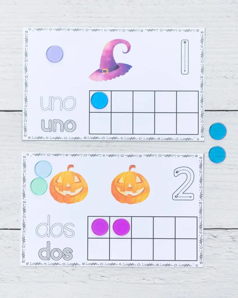 Two printable Halloween ten frame printables with one and two in Spanish.
