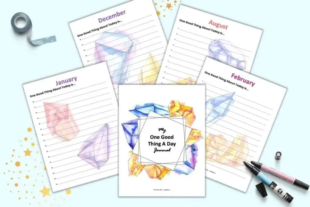A preview of five printable "one good thing a day" journal pages with a watercolor crystal theme. Pages shown include a cover page, January, February, August, and December.