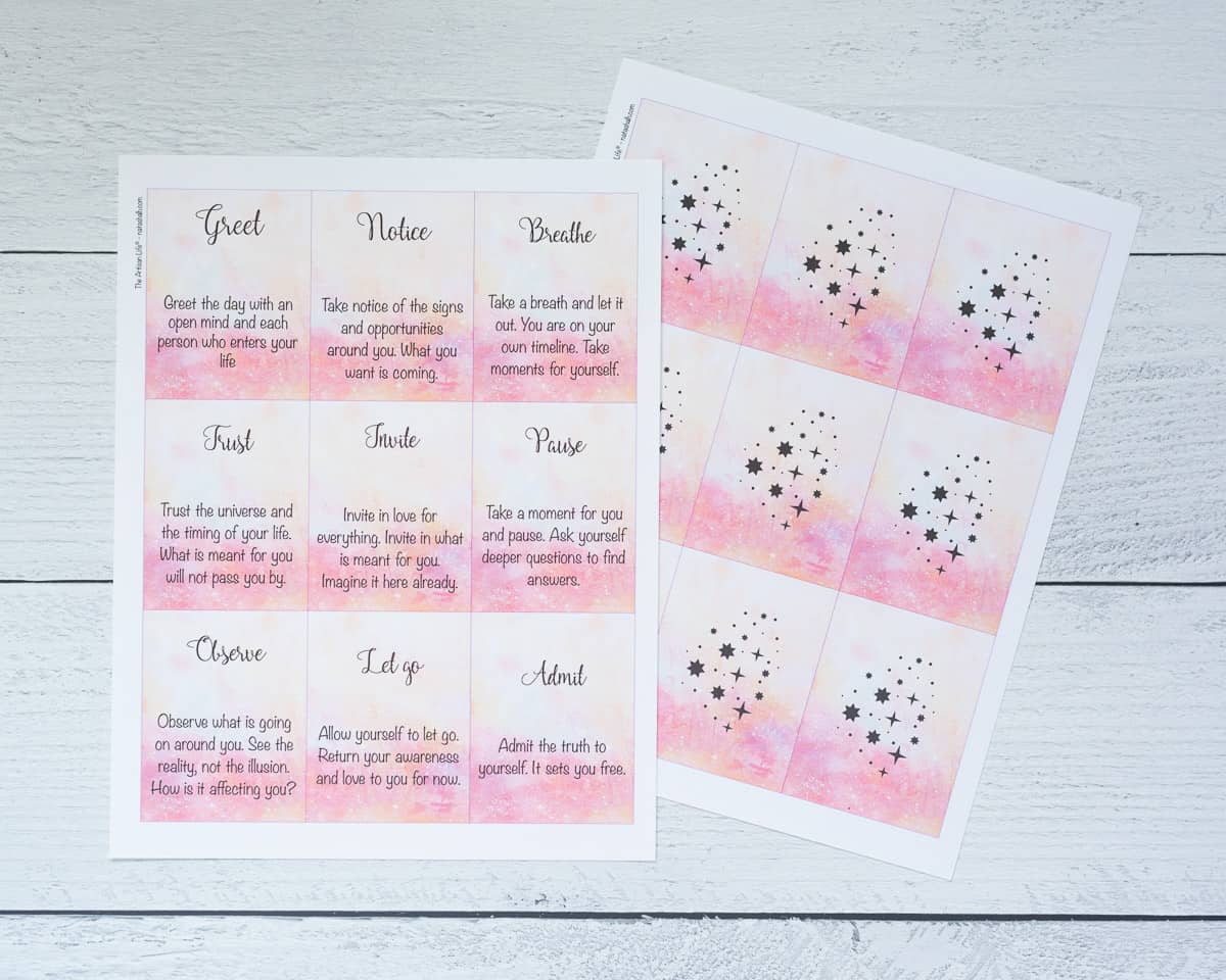 A preview of two printed pages of word of the day oracle cards with a pink watercolor background