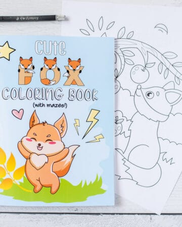 A children's fox coloring book shown with two pages removed, a metal ruler, and a hobby knife