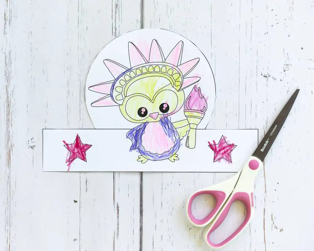 A cut out headband craft showing the Statue of Liberty as a cute owl