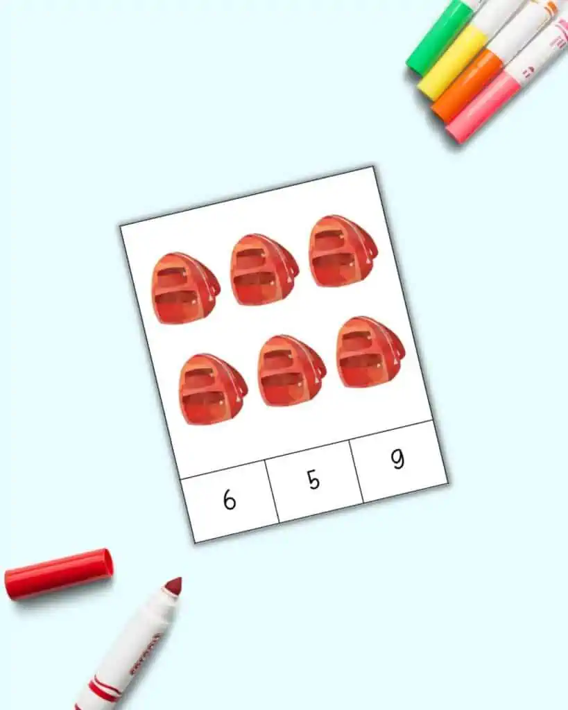 A preview of a count and clip card with six red backpacks and the number choices 6, 5, and 9