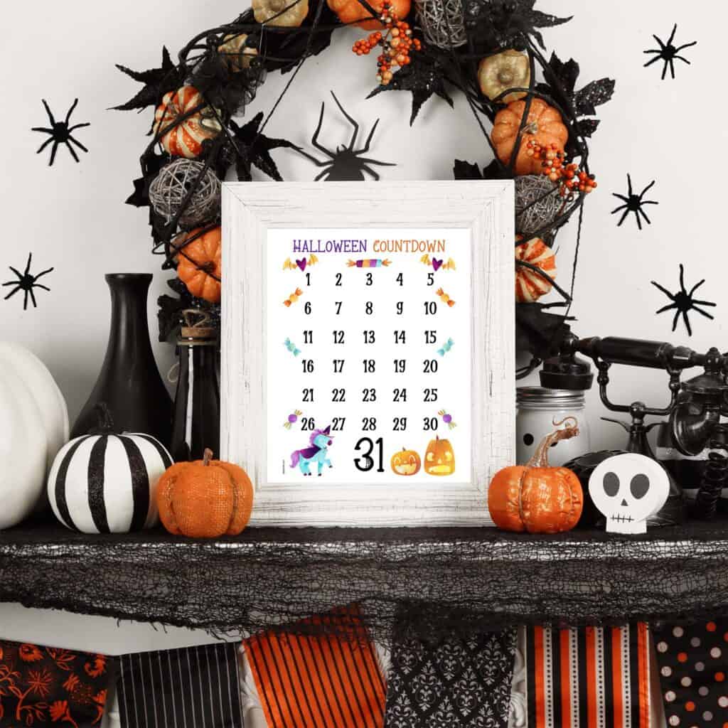 A preview of a Halloween countdown calendar in a white picture frame on a mantle decorated for Halloween