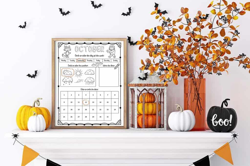 A child's October worksheet calendar printable in a frame on a mantle with Halloween decorations
