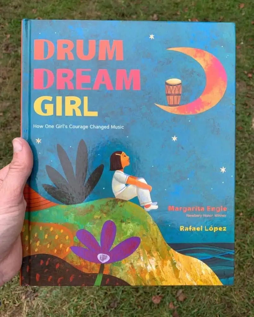 A hadn't holding the book Drum Dream Girl