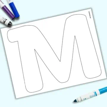 A page with a large bubble letter M. It is shown on a light blue background with colorful children's markers.