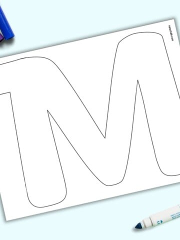 A page with a large bubble letter M. It is shown on a light blue background with colorful children's markers.